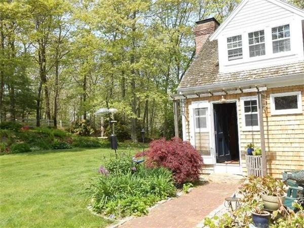 119 Service Road Sandwich, MA 02537 - Photo 23 of 29 a front view of a house with garden