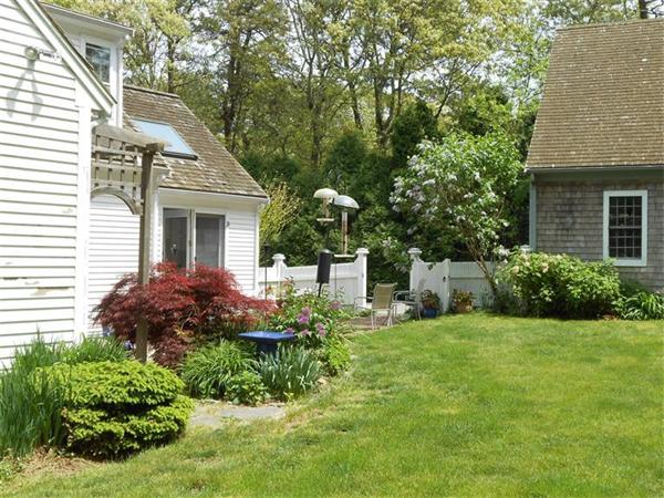 119 Service Road Sandwich, MA 02537 - Photo 24 of 29 a view of a house with a yard and sitting area