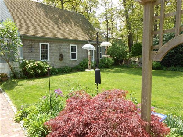 119 Service Road Sandwich, MA 02537 - Photo 25 of 29 a front view of a house with garden