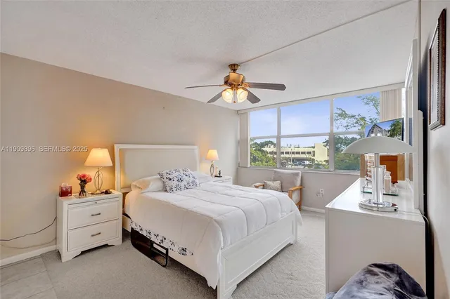 a bed room with a bed and a large window