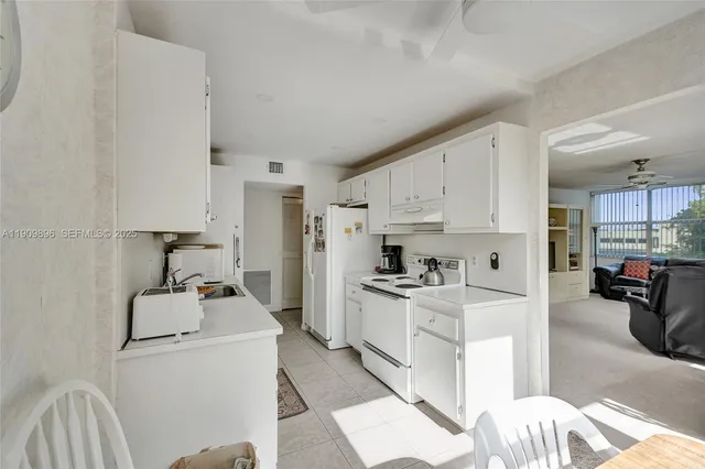 a kitchen with a sink a stove and cabinets