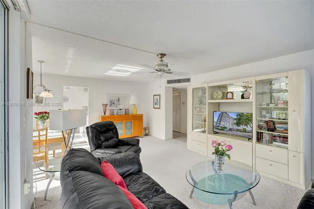 a dining room with furniture a potted plant and a chandelier