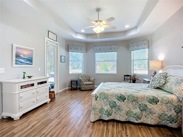 a bathroom with a granite countertop double vanity sink a mirror and a shower