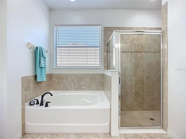 a bathroom with a sink toilet tub and shower