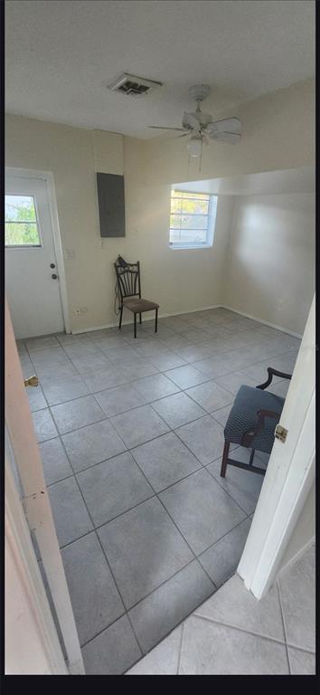 5208 Florida Road Venice, FL 34293 - Photo 11 of 12 a view of an empty room with windows and cabinet