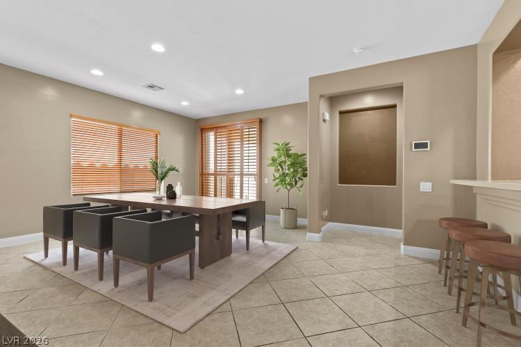 2627 Dirleton Place Henderson, NV 89044 - Photo 14 of 42 Virtually staged -spacious dining area with large windows, flowing into a warm, inviting bar space.