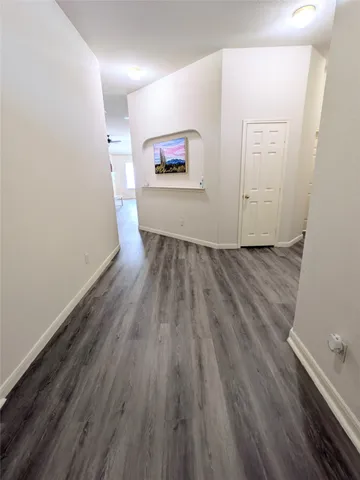 a view of a room with wooden floor