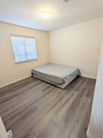 a view of a room with wooden floor and window