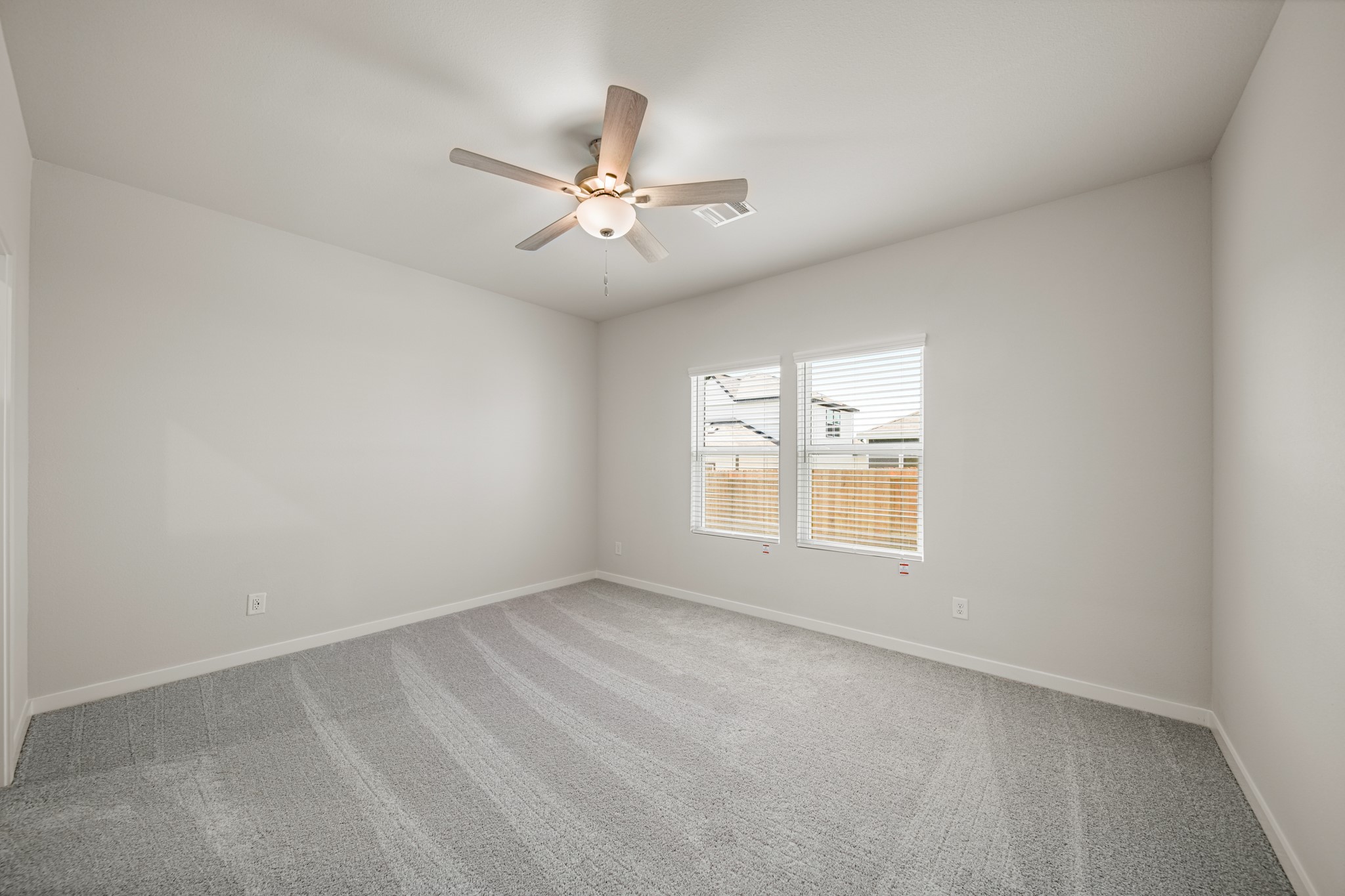 140 Rising Cedar Lane Hockley, TX 77447 - Photo 12 of 24 an empty room with a window and a fan