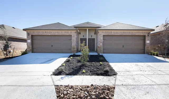 a front view of a house with yard
