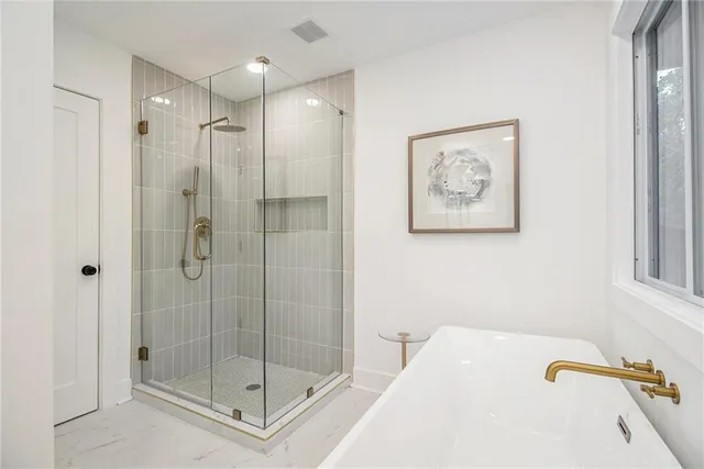 a bathroom with a shower and a sink