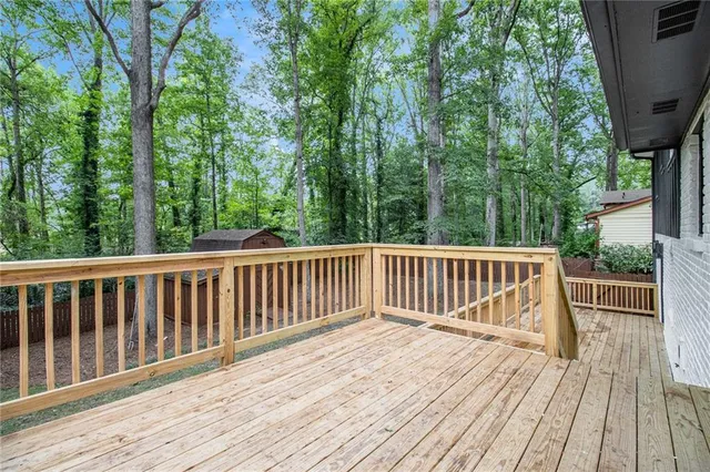 a view of balcony with wooden floor and fence