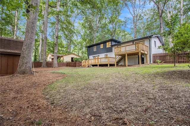 a front view of a house with a yard and trees