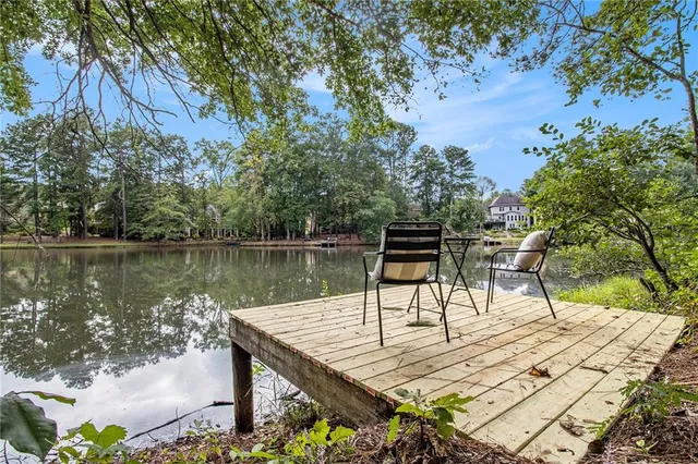 a wooden bench sitting next to a lake