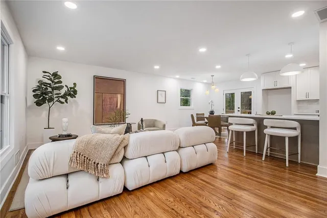a living room with furniture and a wooden floor