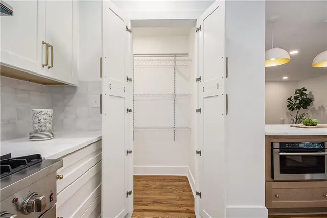 a kitchen with white cabinets and white appliances