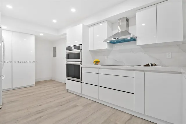 a kitchen with stainless steel appliances a refrigerator and cabinets