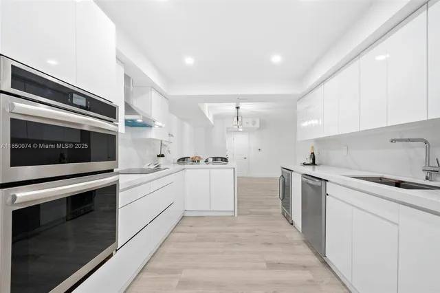 a kitchen with granite countertop cabinets stainless steel appliances and sink