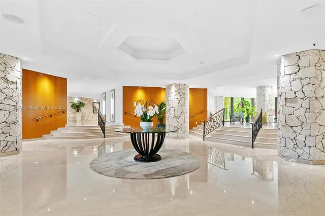 a view of a living room with furniture and a large window