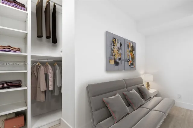 a living room with furniture and a walk in closet