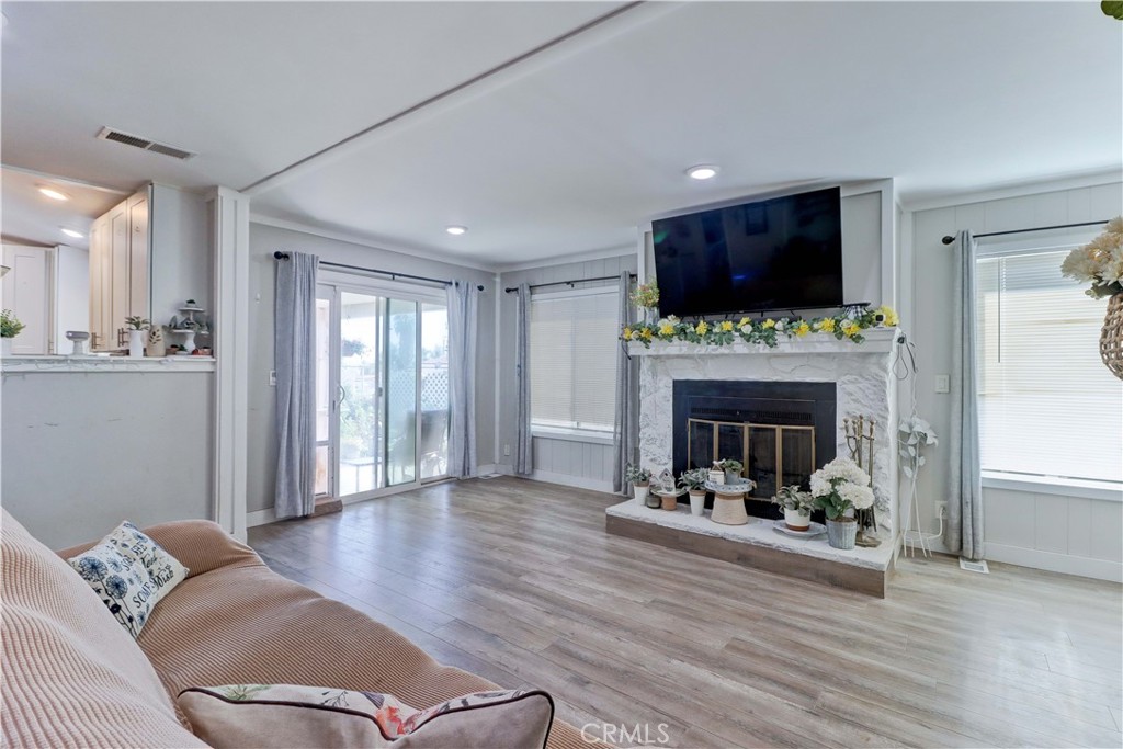 480 Deerhill Road Perris, CA 92570 - Photo 17 of 39 a living room with furniture a flat screen tv and a fireplace