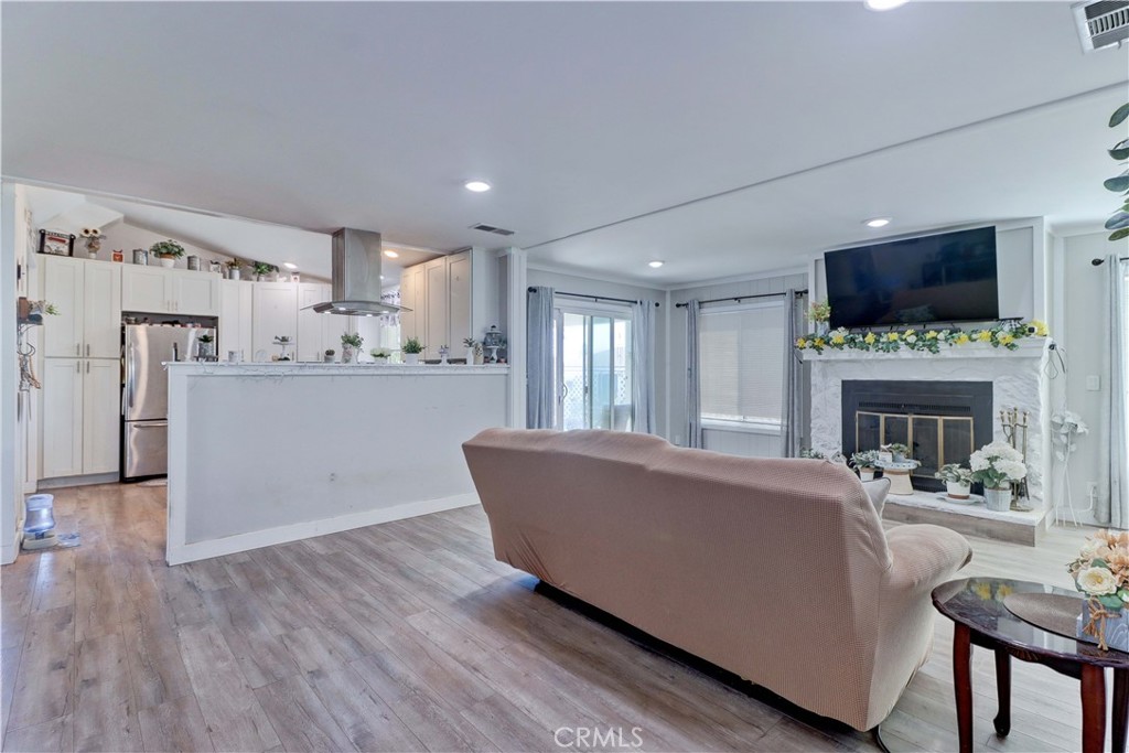 480 Deerhill Road Perris, CA 92570 - Photo 18 of 39 a living room with furniture a fireplace and a flat screen tv