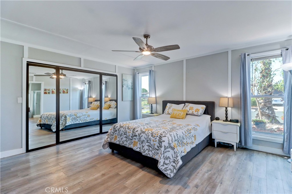 480 Deerhill Road Perris, CA 92570 - Photo 21 of 39 a bedroom with a large bed and a chandelier fan