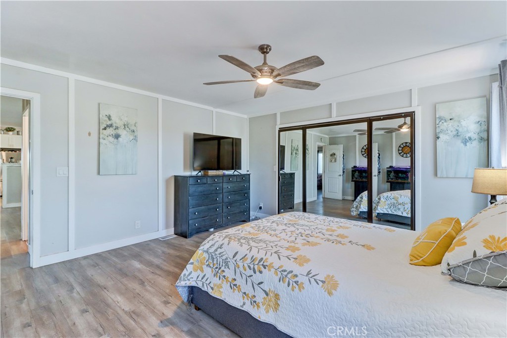 480 Deerhill Road Perris, CA 92570 - Photo 23 of 39 a bedroom with a bed and wooden floor