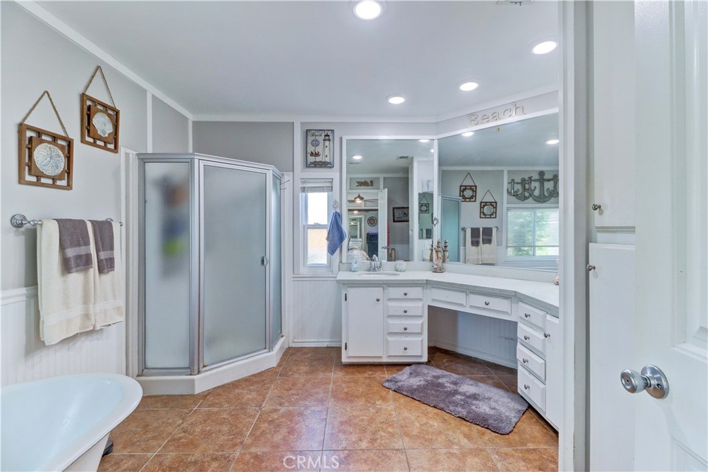 480 Deerhill Road Perris, CA 92570 - Photo 24 of 39 a spacious bathroom with a granite countertop sink and a mirror