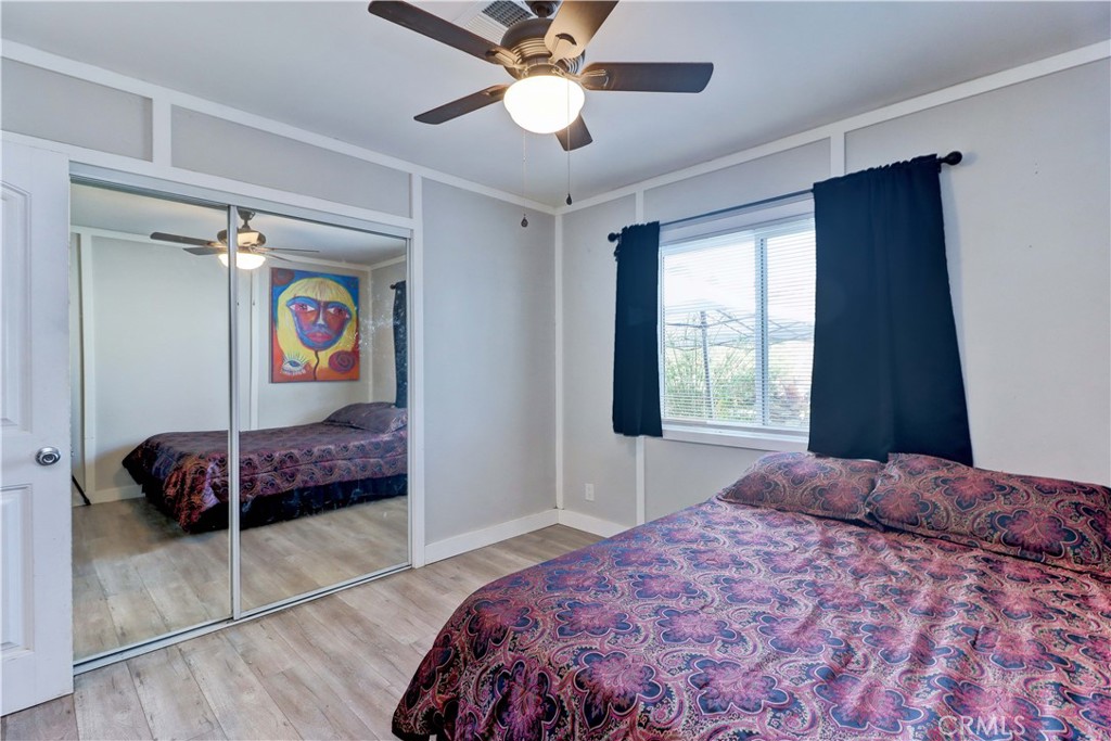 480 Deerhill Road Perris, CA 92570 - Photo 28 of 39 a bedroom with a bed and a chandelier