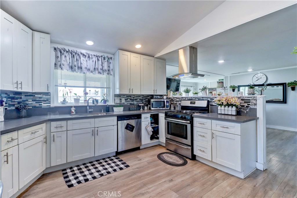 480 Deerhill Road Perris, CA 92570 - Photo 30 of 39 a kitchen with granite countertop a sink appliances cabinets and counter space