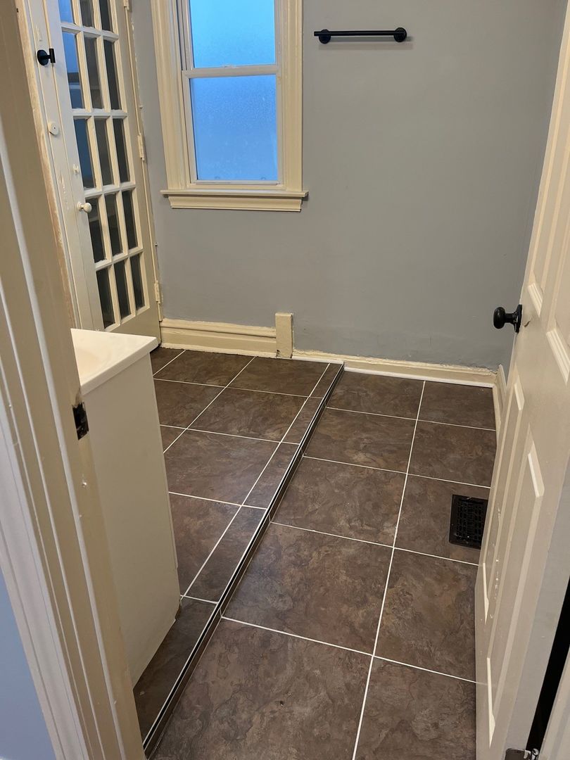 8153 South Exchange Avenue Chicago, IL 60617 - Photo 11 of 11 a bathroom with a sink and a shower