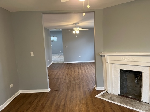 8153 South Exchange Avenue Chicago, IL 60617 - Photo 3 of 11 wooden floor in an empty room with a fireplace
