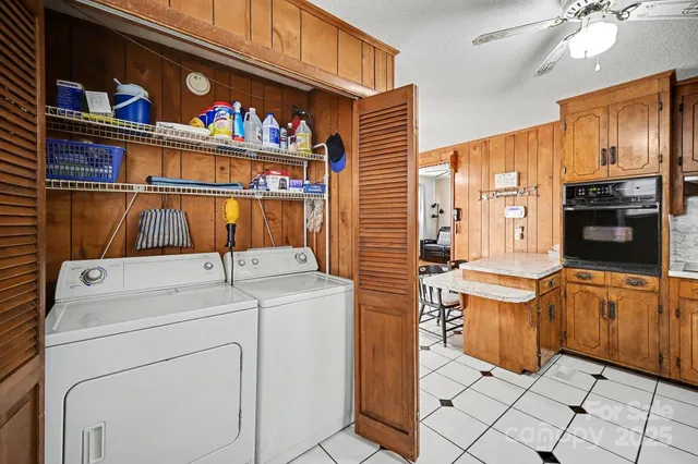 a view of washer and dryer with kitchen in the background