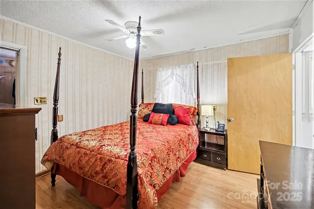 a bedroom with a bed a dresser and a window