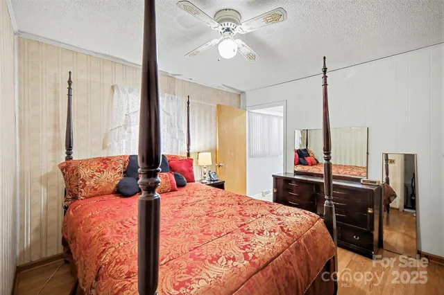 a bedroom with a bed and a chandelier