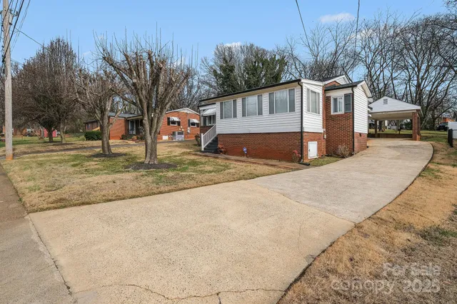 a view of a house with a yard covered in snow