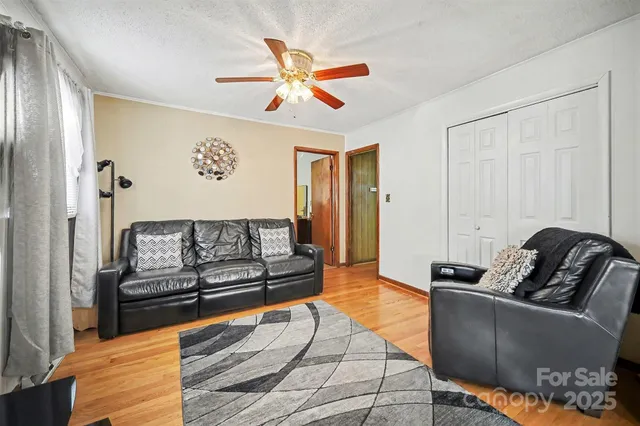 a living room with furniture and a ceiling fan