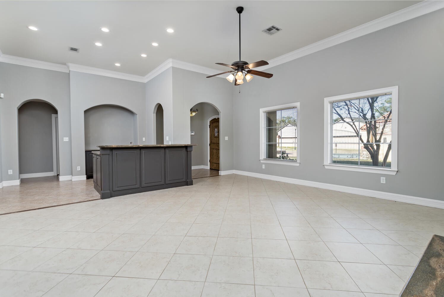 6461 Bell Pointe Beaumont, TX 77706 - Photo 7 of 33 a view of a livingroom with a fireplace a ceiling fan and windows