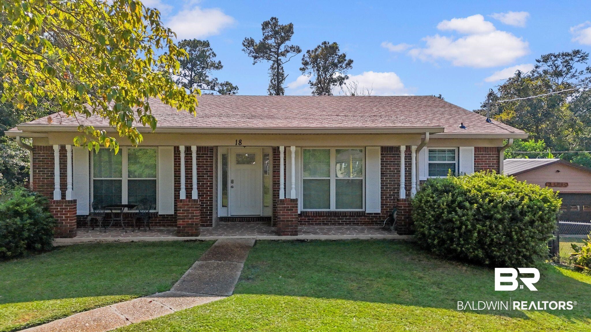 18 Lee Circle Spanish Fort, AL 36527 - Photo 1 of 50 View of front of property with brick siding, a porch, a front lawn, and roof with shingles
