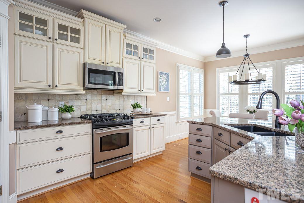 8348 Wheatstone Lane Raleigh, NC 27613 - Photo 2 of 9 a kitchen with stainless steel appliances granite countertop a stove and a sink