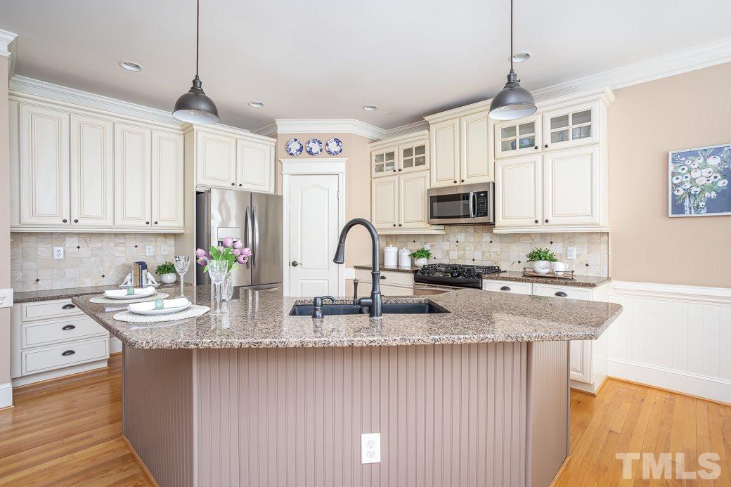8348 Wheatstone Lane Raleigh, NC 27613 - Photo 3 of 9 a kitchen with sink a microwave and cabinets