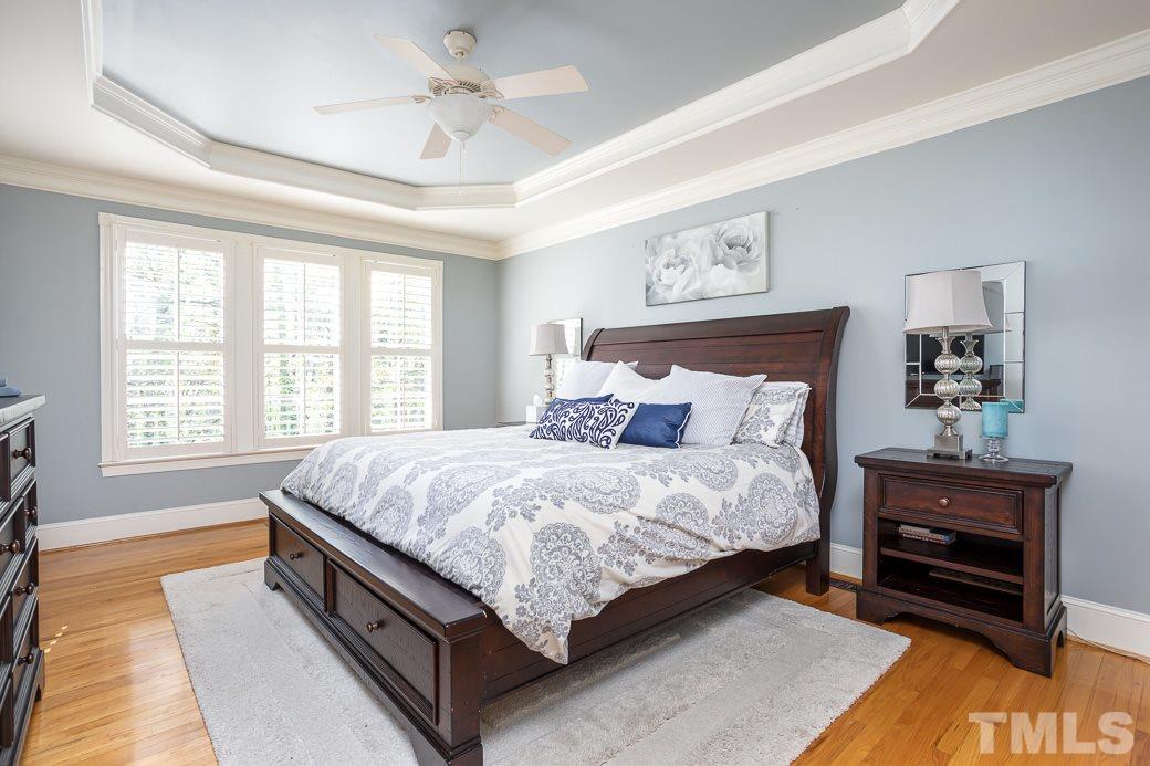 8348 Wheatstone Lane Raleigh, NC 27613 - Photo 5 of 9 a large bed sitting in a bedroom next to a window