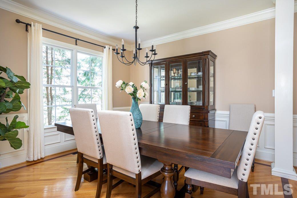 8348 Wheatstone Lane Raleigh, NC 27613 - Photo 7 of 9 a view of a dining room with furniture window and wooden floor