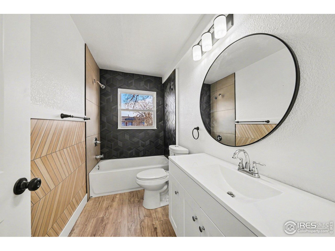 2202 17th Street Greeley, CO 80631 - Photo 18 of 36 a bathroom with a sink a toilet and a mirror