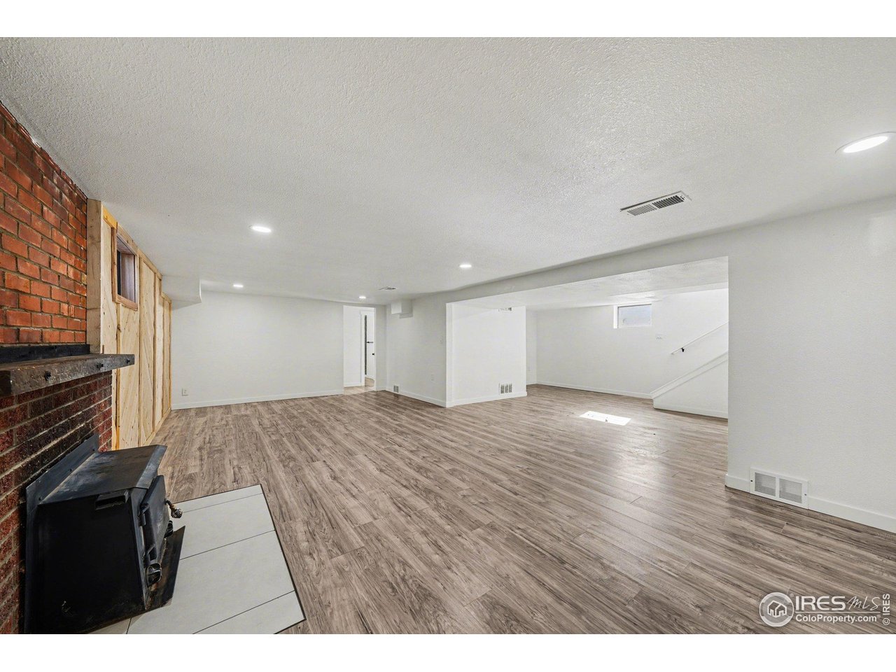 2202 17th Street Greeley, CO 80631 - Photo 22 of 36 a view of an empty room and wooden floor