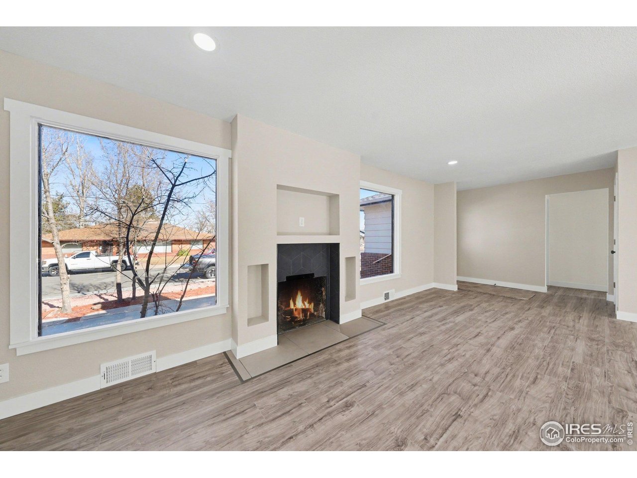 2202 17th Street Greeley, CO 80631 - Photo 5 of 36 a view of an empty room with a window and fireplace