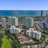 a kitchen with stainless steel appliances granite countertop a stove top oven a sink a dining table and chairs