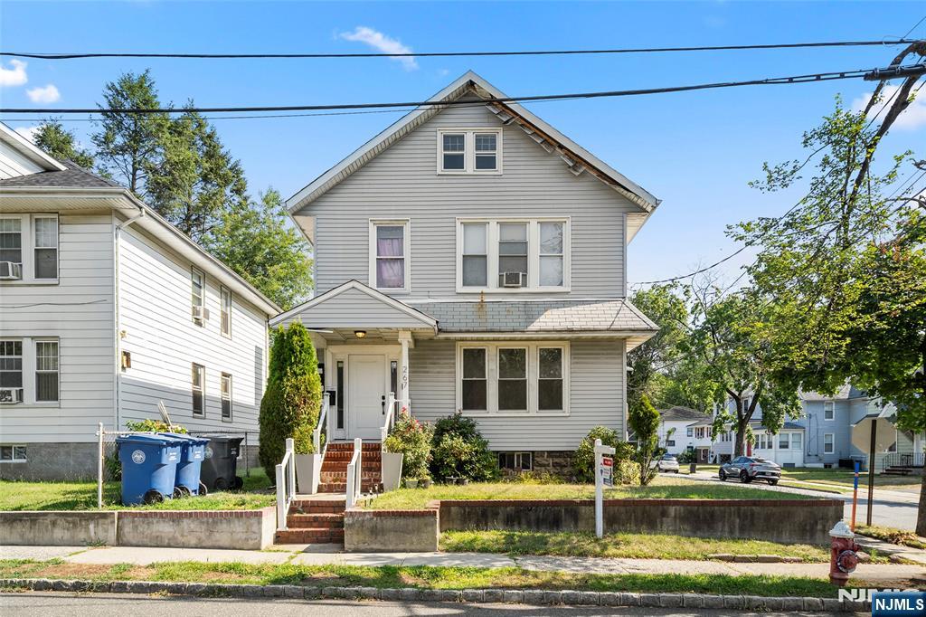 267 Hirliman Road Englewood, NJ 07631 - Photo 1 of 16 a front view of a house with a white house next to a yard