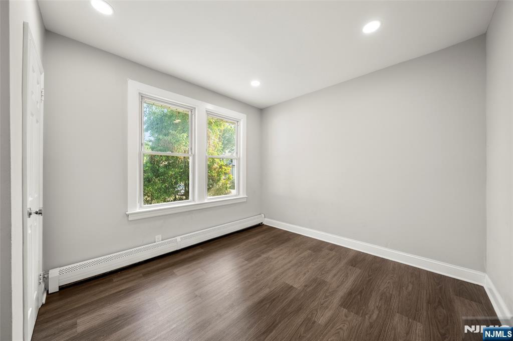 267 Hirliman Road Englewood, NJ 07631 - Photo 12 of 16 an empty room with wooden floor and windows